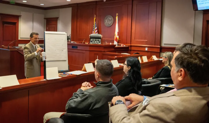 Trial court administrator meets with new employees during orientation